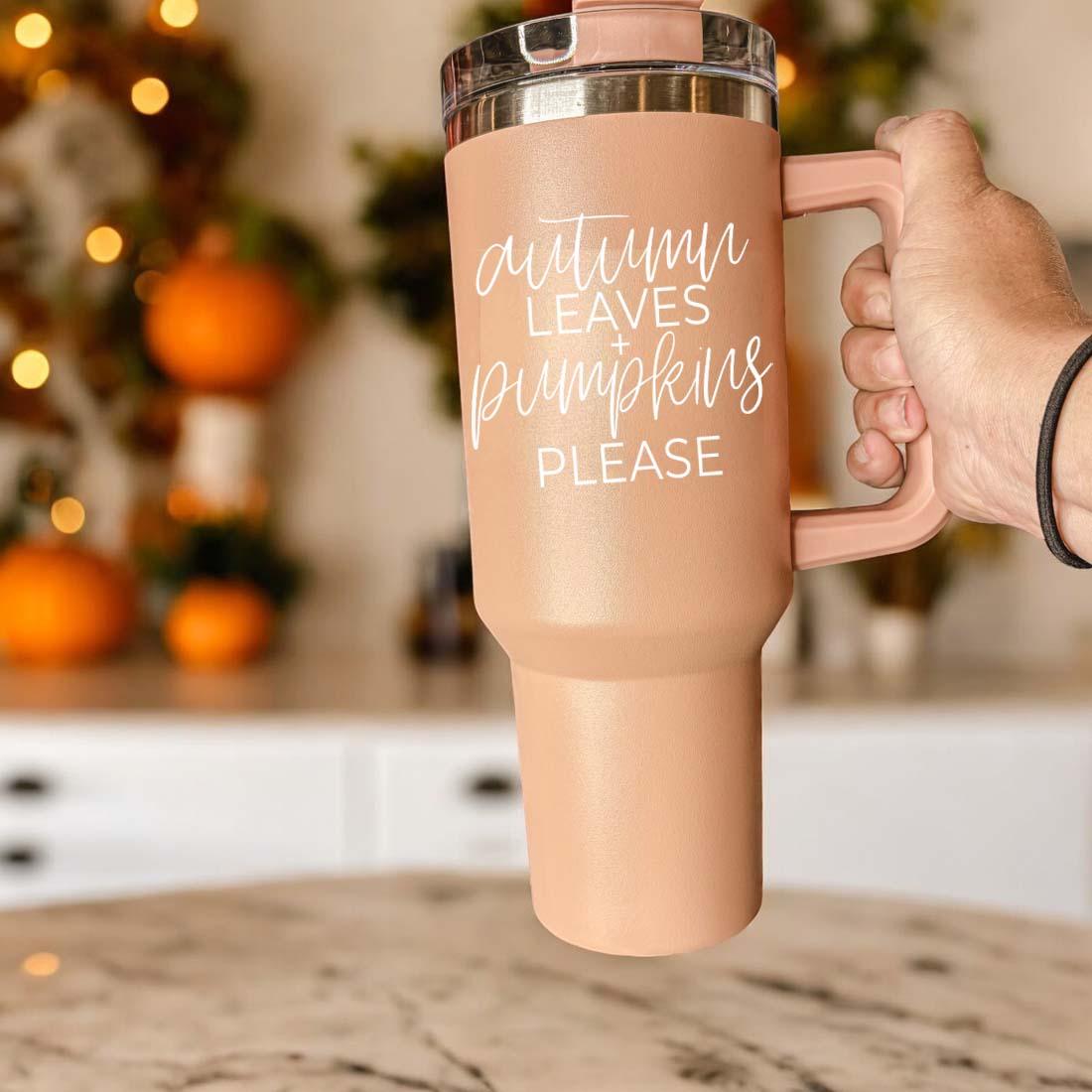 A stylish 40oz tumbler featuring an autumn leaves design with the phrase 'Autumn Leaves + Pumpkins Please', perfect for fall beverages.