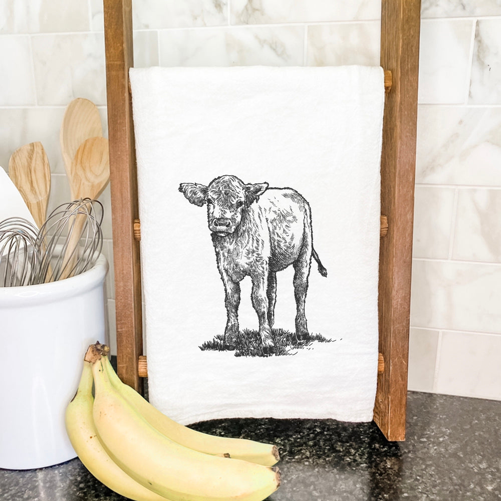 A vibrant Baby Cow Cotton Tea Towel featuring a whimsical cow design, made from 100% absorbent cotton, perfect for kitchen use.