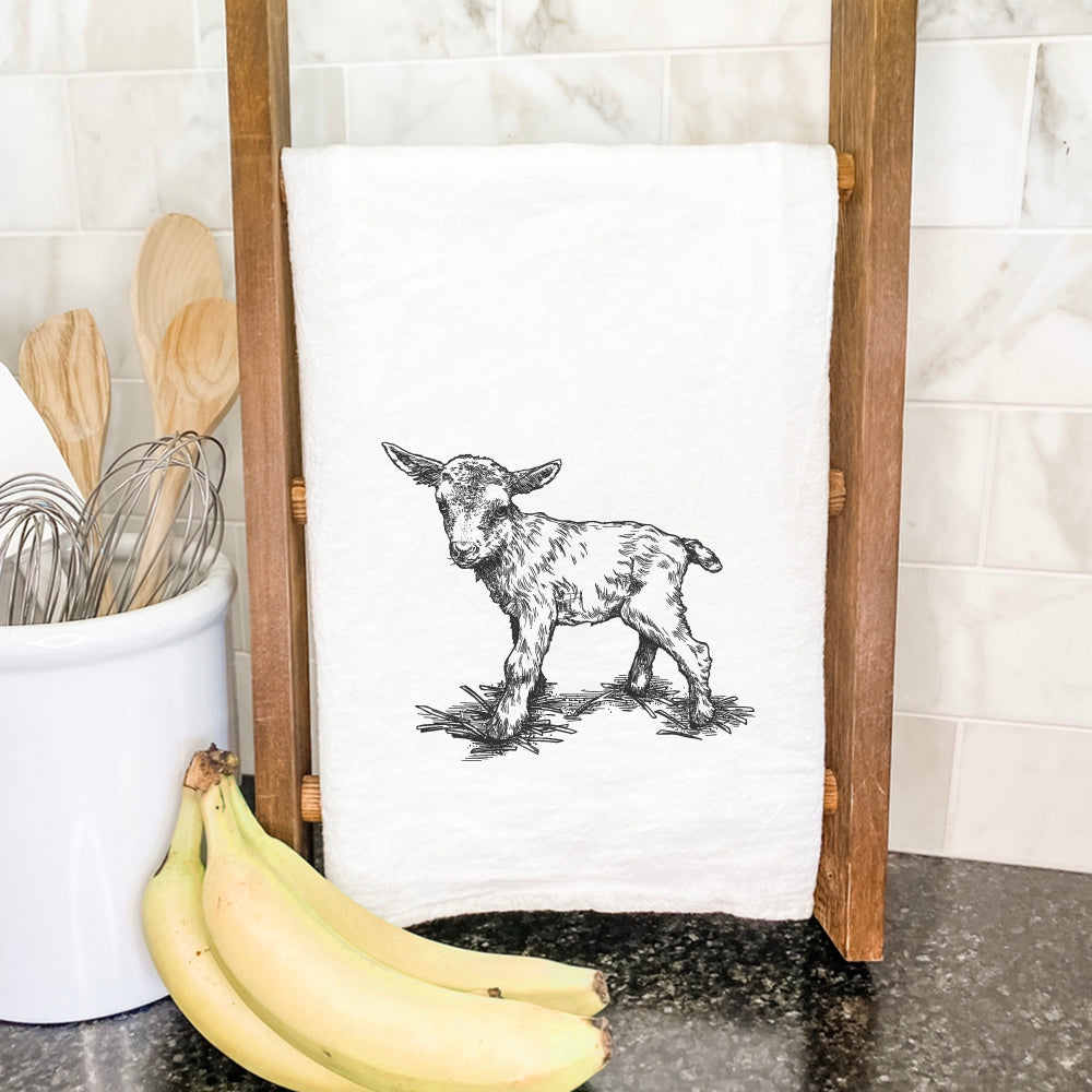 A vibrant Baby Goat Cotton Tea Towel featuring a whimsical goat design, made from 100% absorbent cotton, perfect for kitchen use.