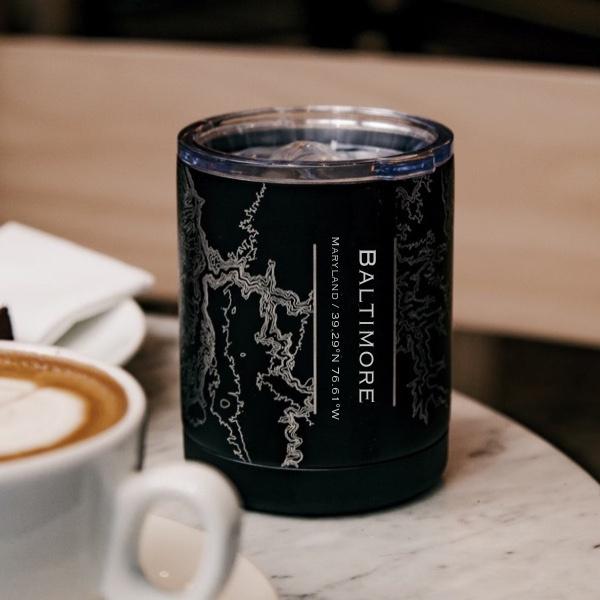 Matte black insulated cup featuring a custom engraved map of Baltimore, Maryland with coordinates.