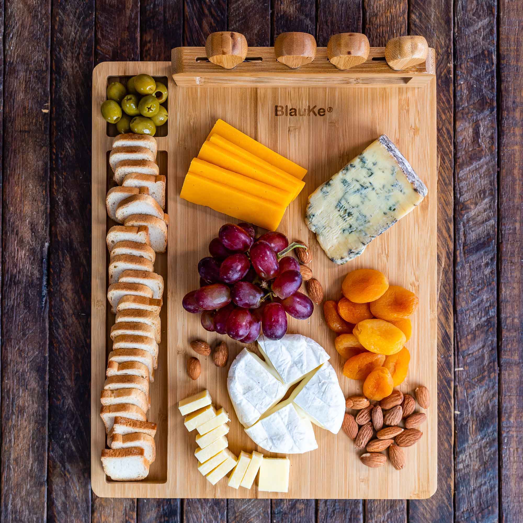 Elegant bamboo cheese board and knife set, featuring a 14x11 inch surface with included cheese knives and serving fork.