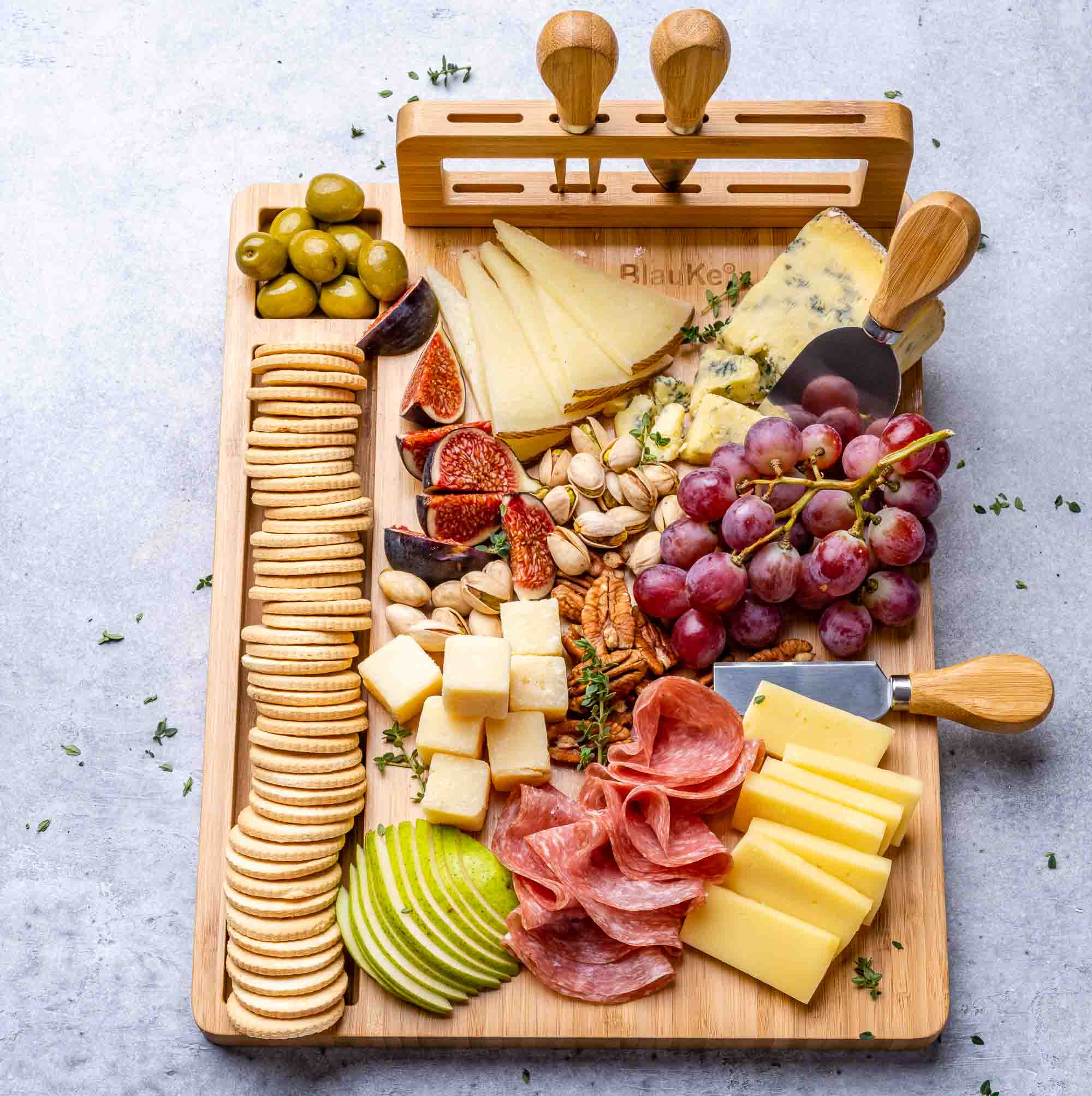 Elegant bamboo cheese board and knife set, featuring a 14x11 inch surface with included cheese knives and serving fork.