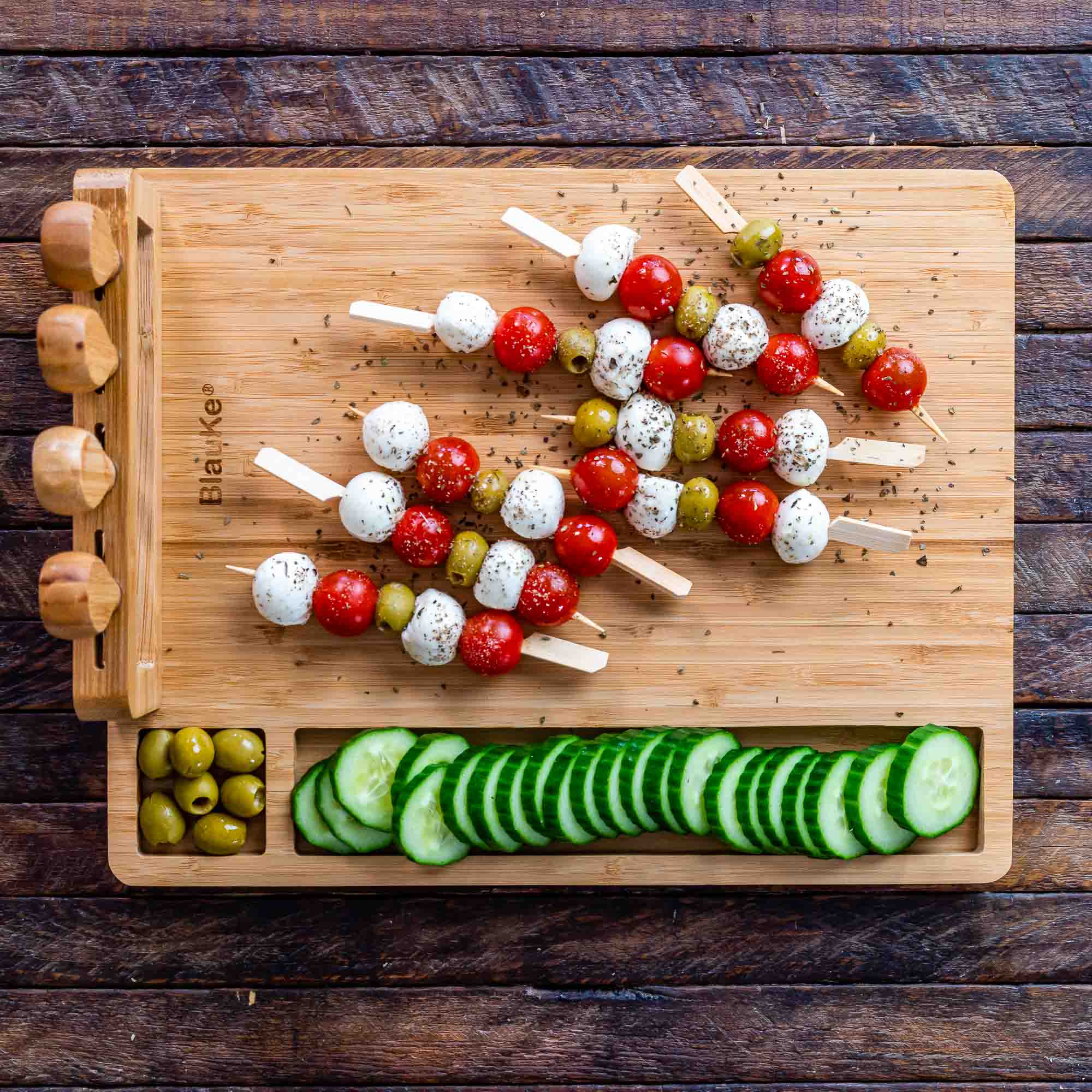 Elegant bamboo cheese board and knife set, featuring a 14x11 inch surface with included cheese knives and serving fork.