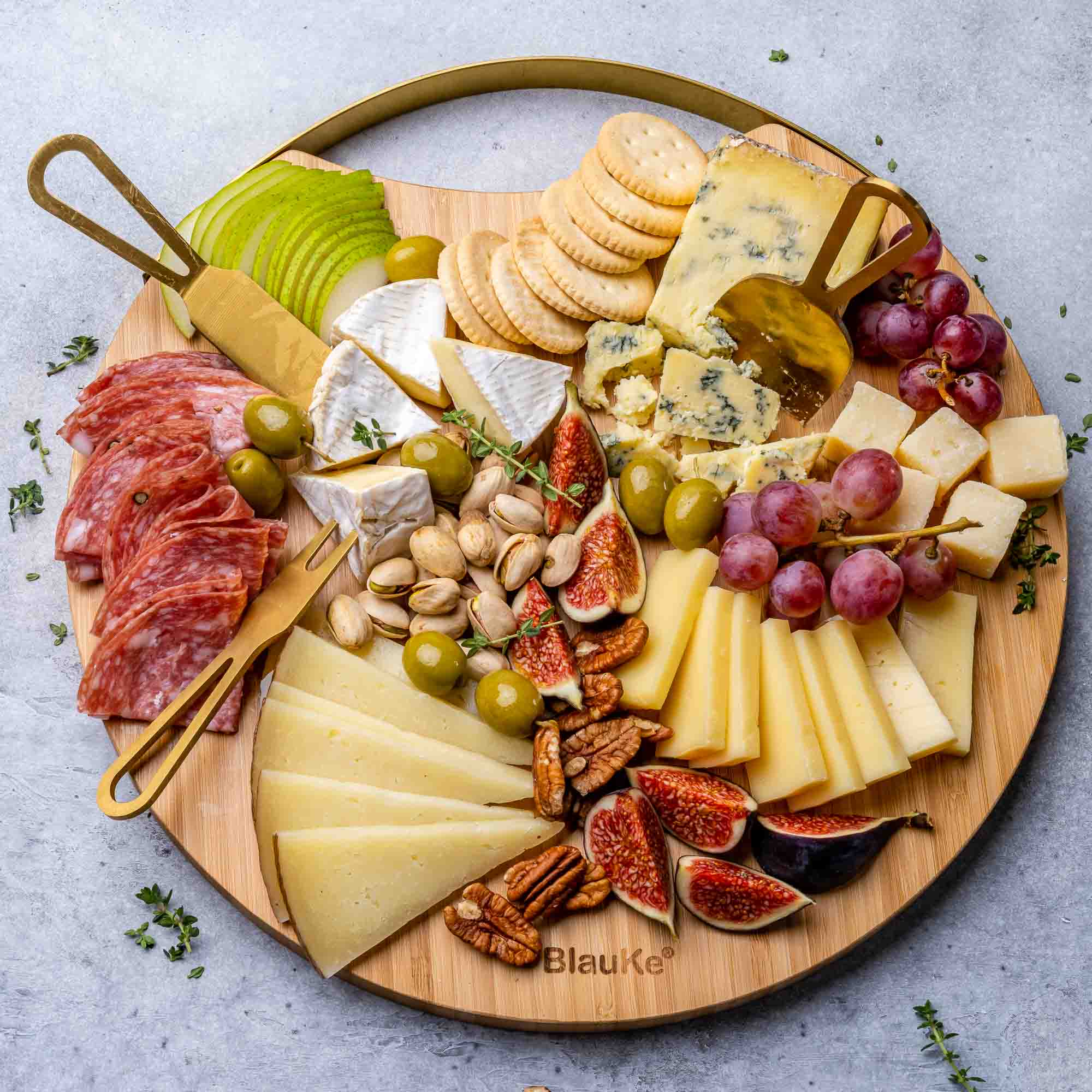 A stylish 13-inch bamboo cheese board with magnetic knife storage, featuring a spatula knife, plane knife, and serving fork, elegantly arranged for serving.