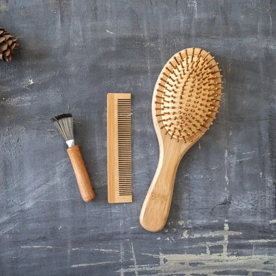 Bamboo Hair Brush Set including a round brush, bamboo comb, and brush cleaner in a reusable travel bag.