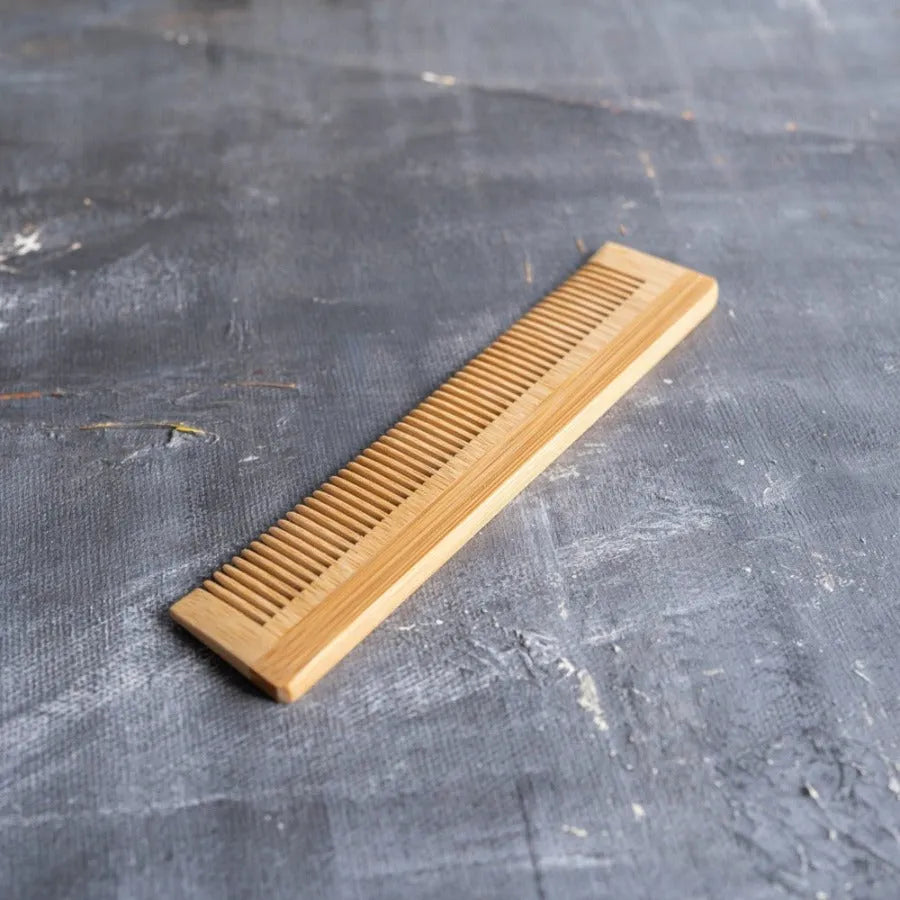 Bamboo Hair Brush Set including a round brush, bamboo comb, and brush cleaner in a reusable travel bag.