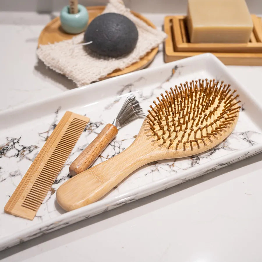 Bamboo Hair Brush Set including a round brush, bamboo comb, and brush cleaner in a reusable travel bag.