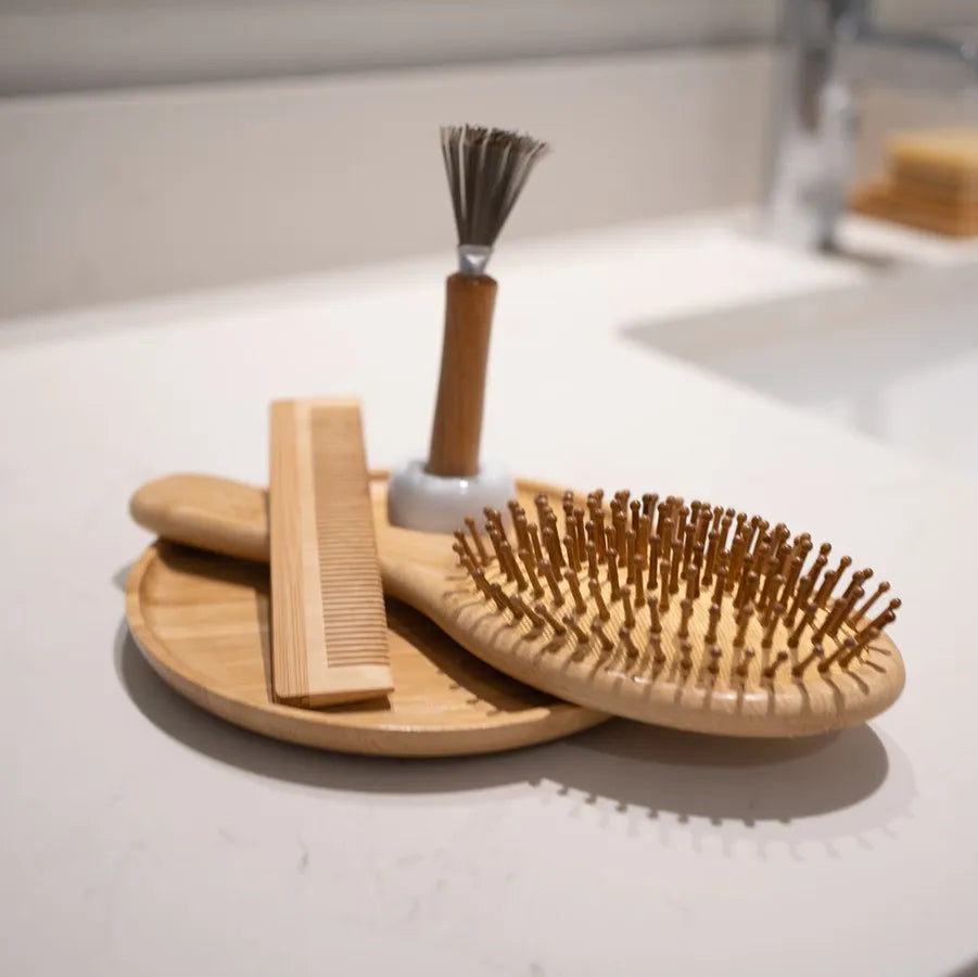 Bamboo Hair Brush Set including a round brush, bamboo comb, and brush cleaner in a reusable travel bag.