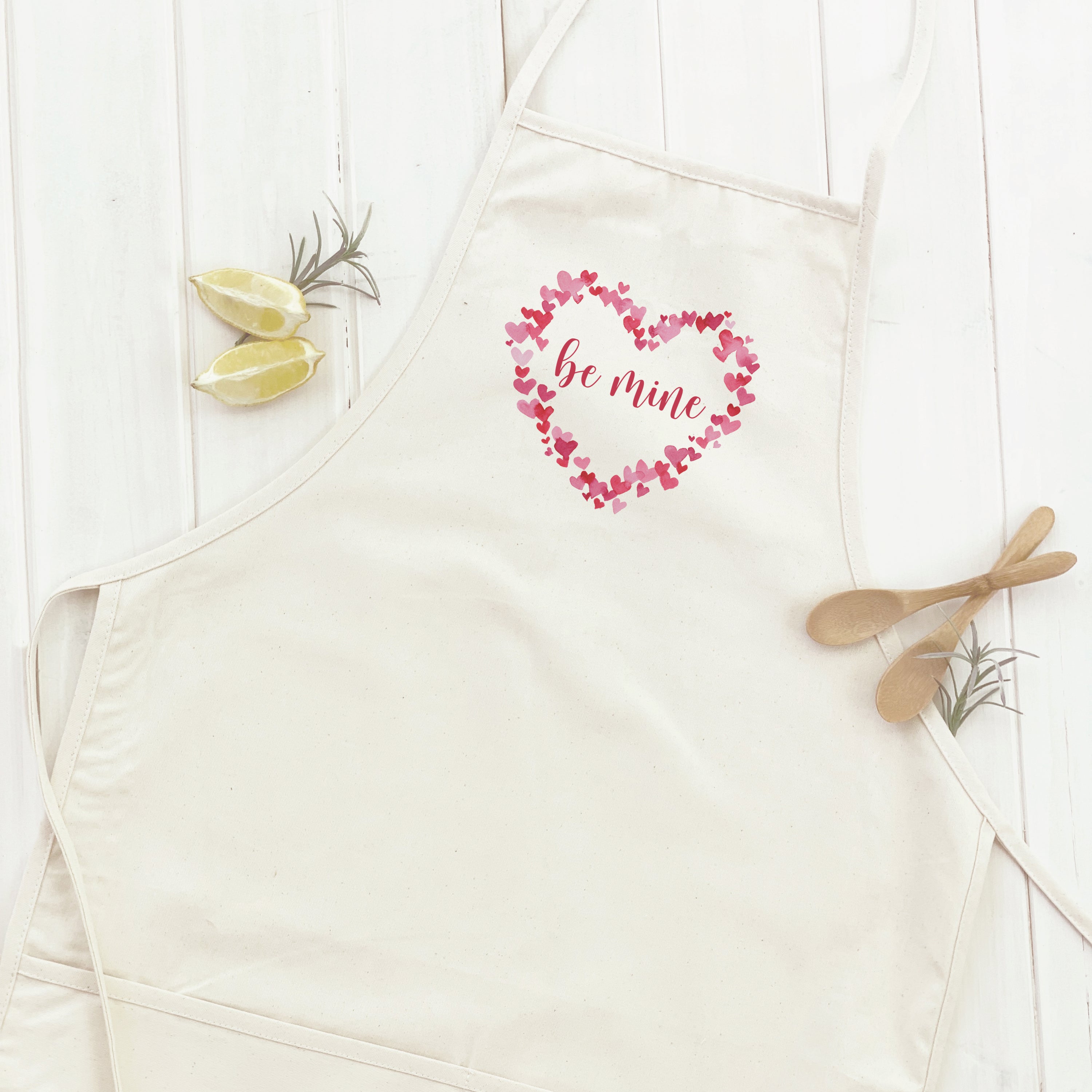 Be Mine Women's Apron in elegant design, made from durable cotton canvas with adjustable neck and divided front pocket.