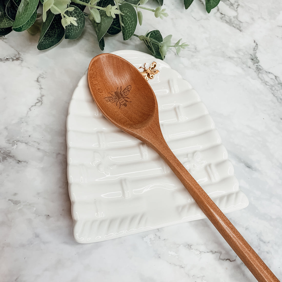 Bee Spoon Rest with a bee skep design and a wooden spoon engraved with a bee icon, perfect for bee lovers.