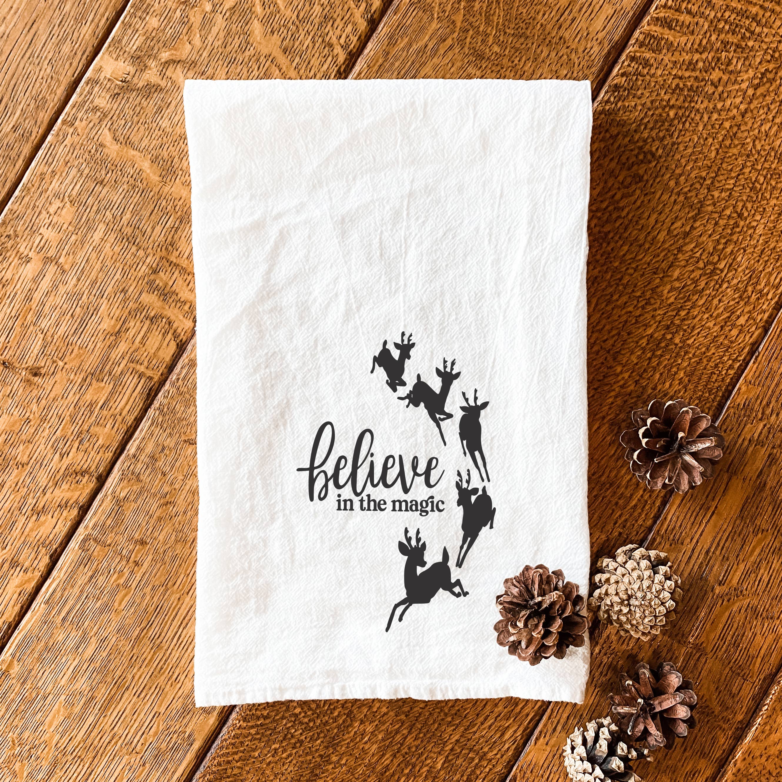 Believe in the Magic cotton tea towel featuring vibrant designs, perfect for kitchen use.