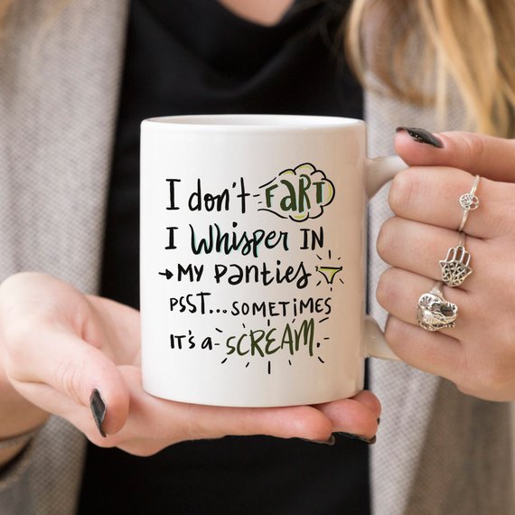 Funny coffee mug with the phrase 'I Don't Fart. I Whisper' printed on it, showcasing a humorous design perfect for gifts.