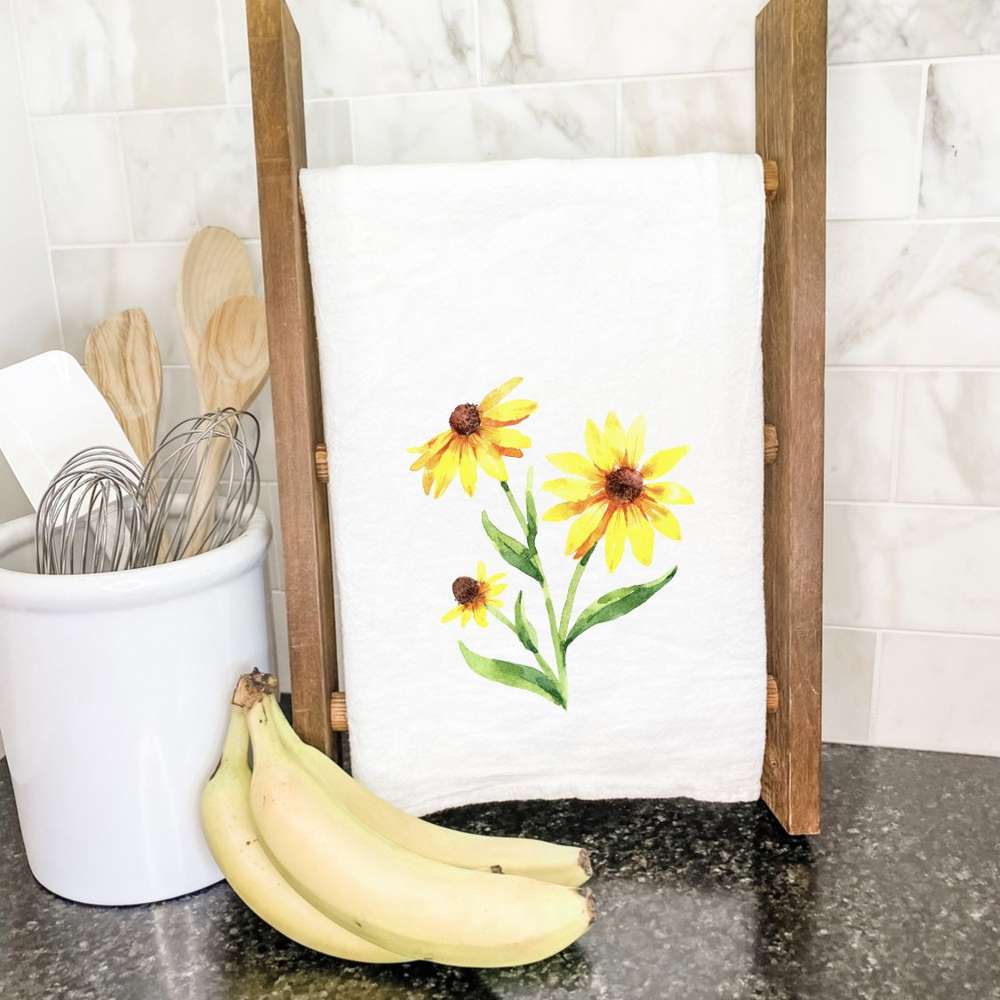 Black-Eyed Susan Cotton Tea Towel featuring vibrant floral design, hemmed edges, and absorbent fabric, perfect for kitchen use.