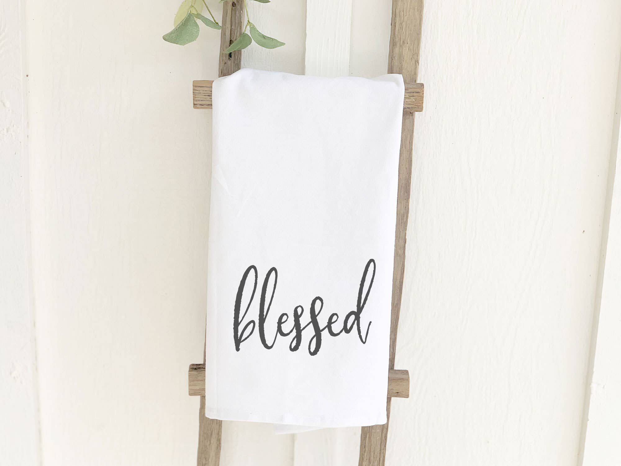 A beautifully designed Blessed Cotton Tea Towel featuring vibrant colors and hemmed edges, perfect for kitchen use.