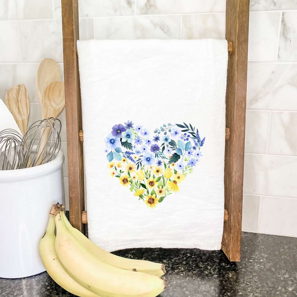 Blue and yellow heart patterned cotton tea towel, showcasing vibrant colors and hemmed edges, perfect for kitchen use.