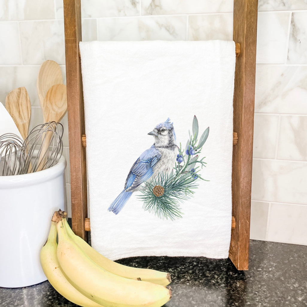 A vibrant Blue Jay cotton tea towel featuring a beautiful bird design, perfect for kitchen use.