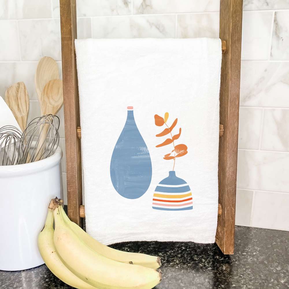 A vibrant cotton tea towel featuring a beautiful blue vases design, perfect for kitchen use.