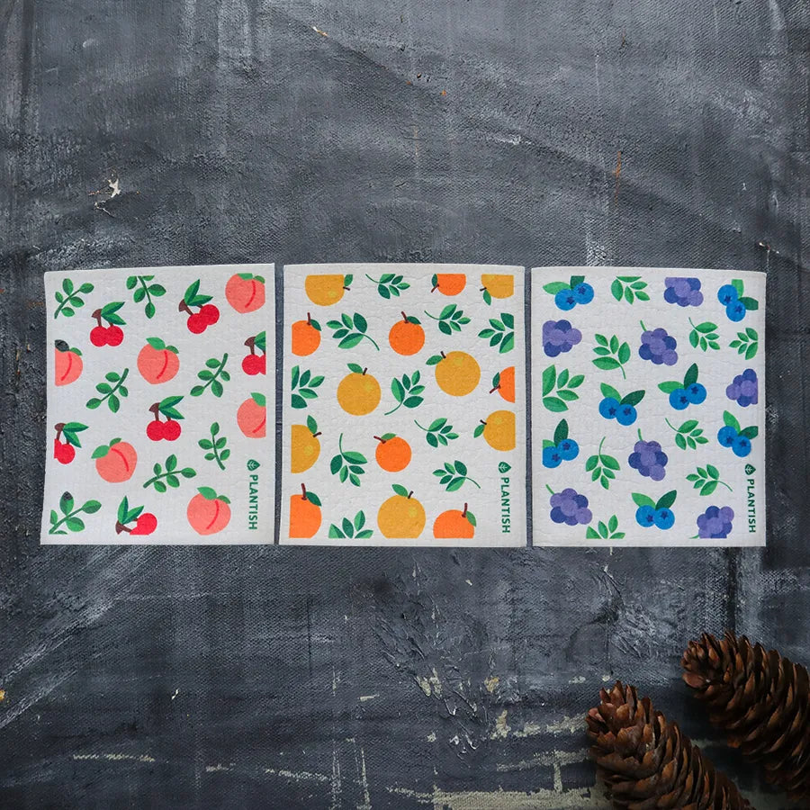 Colorful fruit-patterned dishcloths on display.