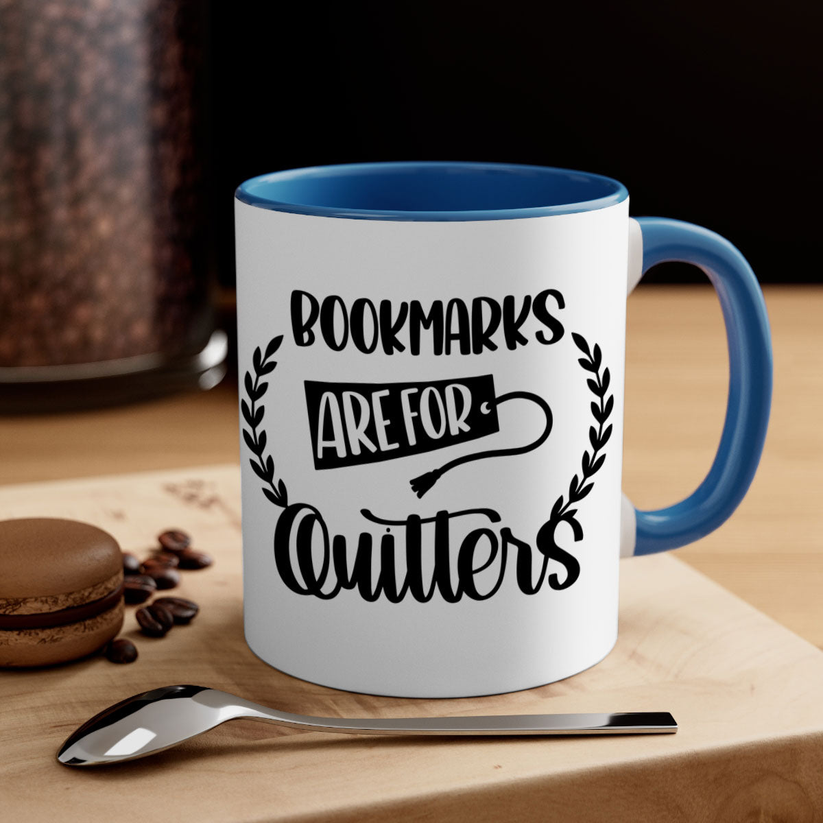 A stylish two-tone ceramic mug with the phrase 'Bookmarks Are for Quitters', featuring a colored handle and glossy finish.