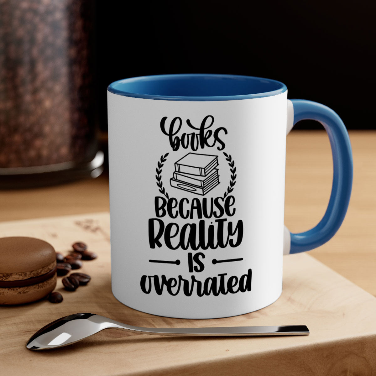 A two-tone ceramic mug with the phrase 'Books Because Reality is Overrated' printed on it, featuring a colored handle and glossy finish.