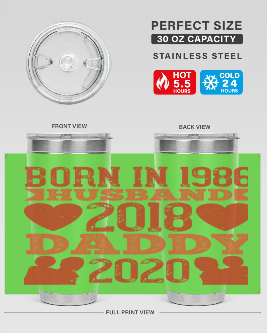 A stylish 'Born in Husband Daddy' tumbler in stainless steel, showcasing its double wall vacuum design and drink-thru lid.