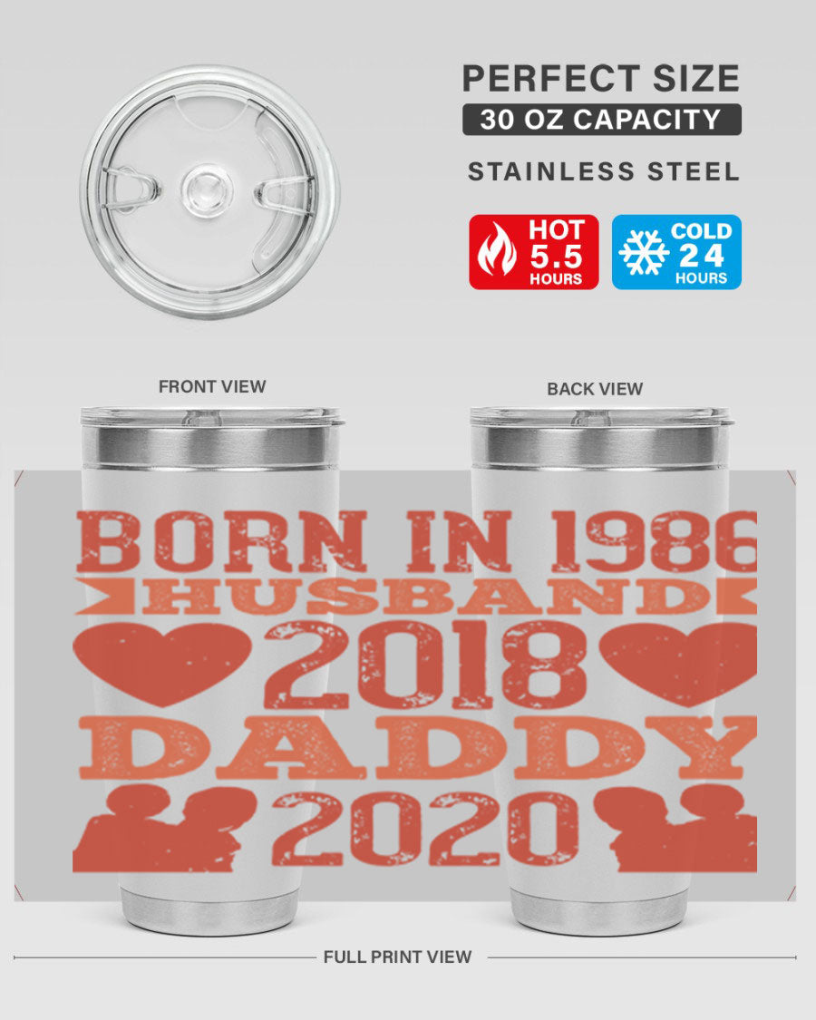 A stylish 'Born in Husband Daddy' tumbler in stainless steel, showcasing its double wall vacuum design and drink-thru lid.