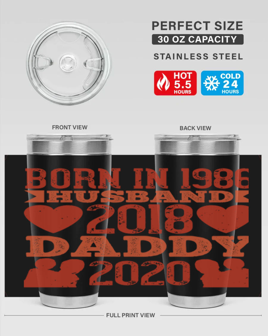 A stylish 'Born in Husband Daddy' tumbler in stainless steel, showcasing its double wall vacuum design and drink-thru lid.