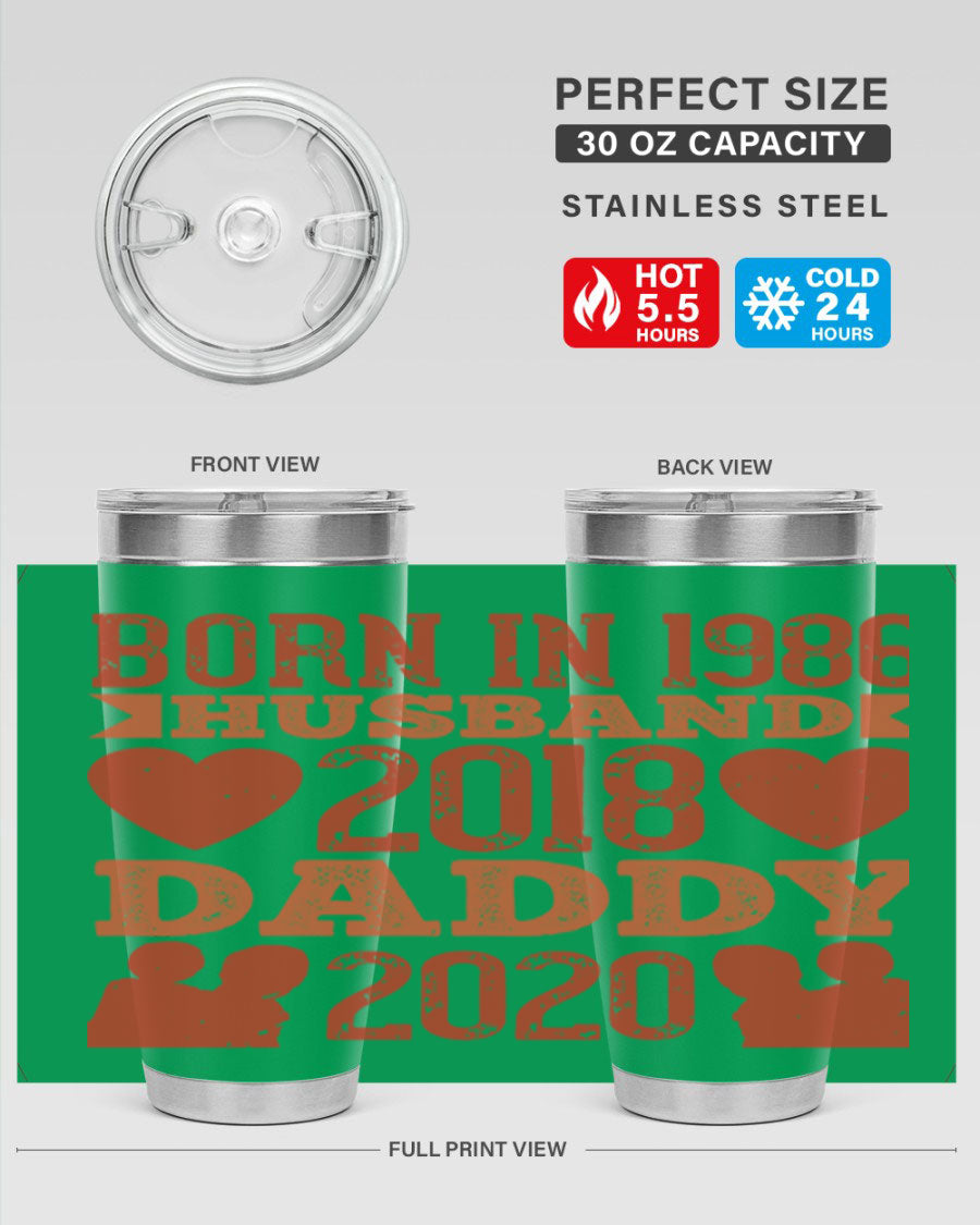 A stylish 'Born in Husband Daddy' tumbler in stainless steel, showcasing its double wall vacuum design and drink-thru lid.