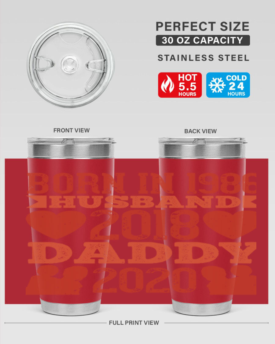 A stylish 'Born in Husband Daddy' tumbler in stainless steel, showcasing its double wall vacuum design and drink-thru lid.