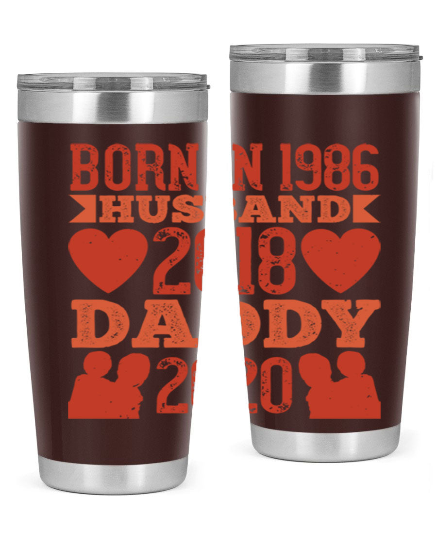 A stylish 'Born in Husband Daddy' tumbler in stainless steel, showcasing its double wall vacuum design and drink-thru lid.