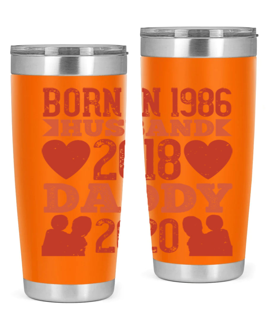 A stylish 'Born in Husband Daddy' tumbler in stainless steel, showcasing its double wall vacuum design and drink-thru lid.