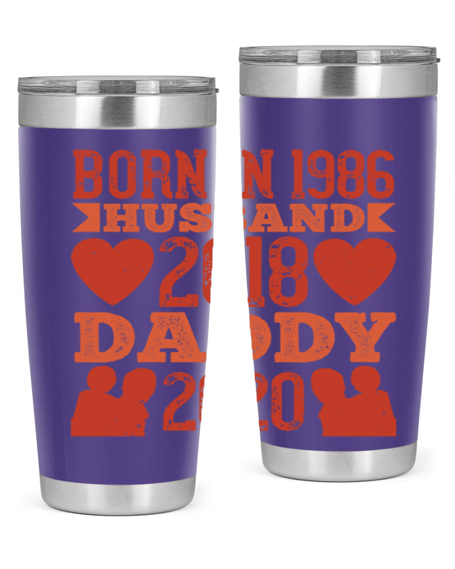 A stylish 'Born in Husband Daddy' tumbler in stainless steel, showcasing its double wall vacuum design and drink-thru lid.