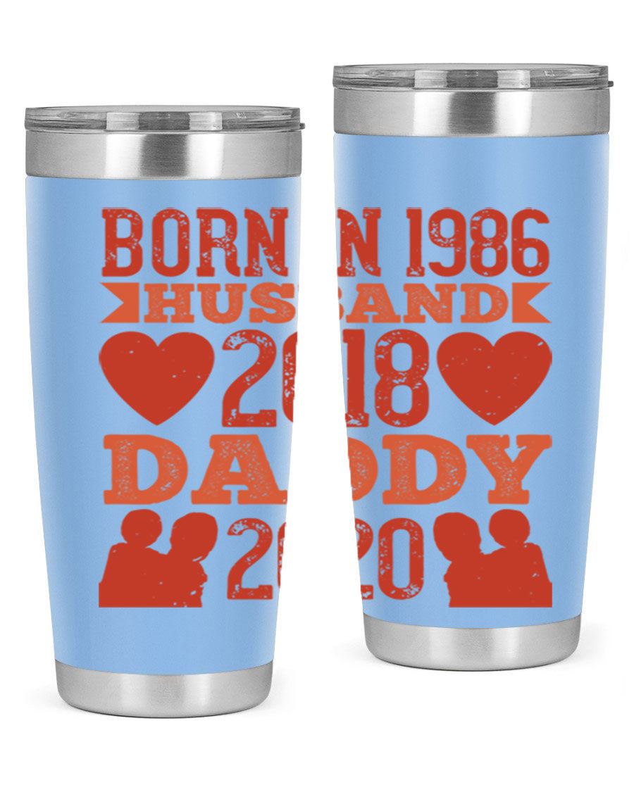 A stylish 'Born in Husband Daddy' tumbler in stainless steel, showcasing its double wall vacuum design and drink-thru lid.