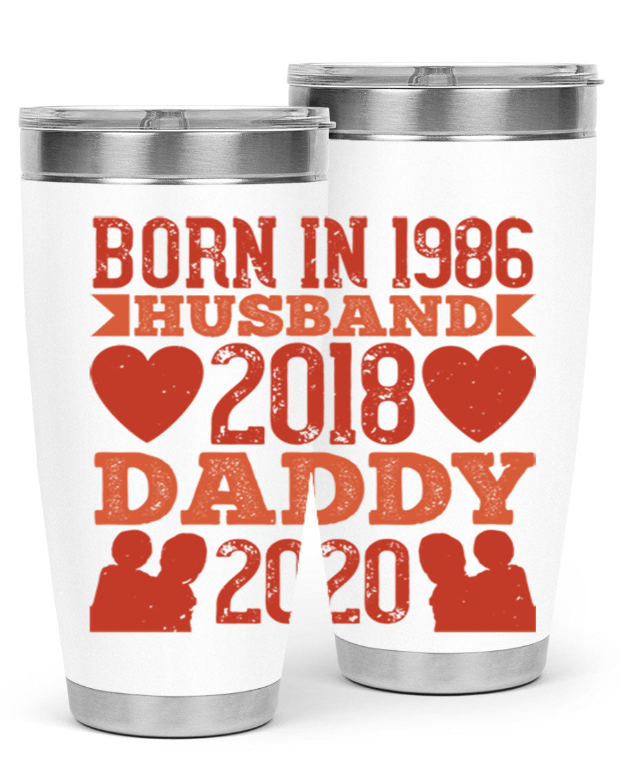 A stylish 'Born in Husband Daddy' tumbler in stainless steel, showcasing its double wall vacuum design and drink-thru lid.