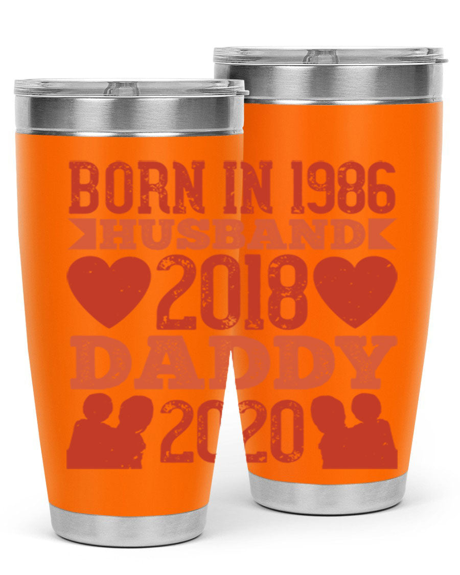 A stylish 'Born in Husband Daddy' tumbler in stainless steel, showcasing its double wall vacuum design and drink-thru lid.