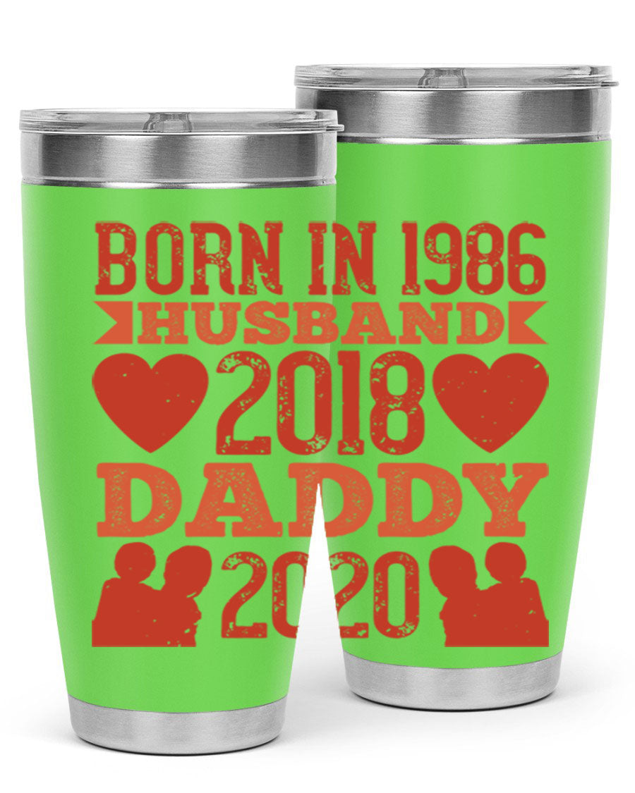 A stylish 'Born in Husband Daddy' tumbler in stainless steel, showcasing its double wall vacuum design and drink-thru lid.