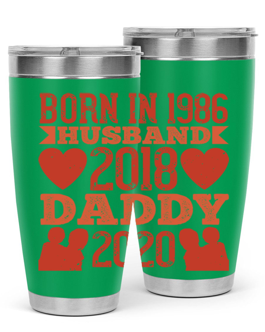 A stylish 'Born in Husband Daddy' tumbler in stainless steel, showcasing its double wall vacuum design and drink-thru lid.