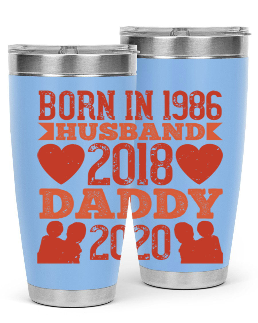 A stylish 'Born in Husband Daddy' tumbler in stainless steel, showcasing its double wall vacuum design and drink-thru lid.