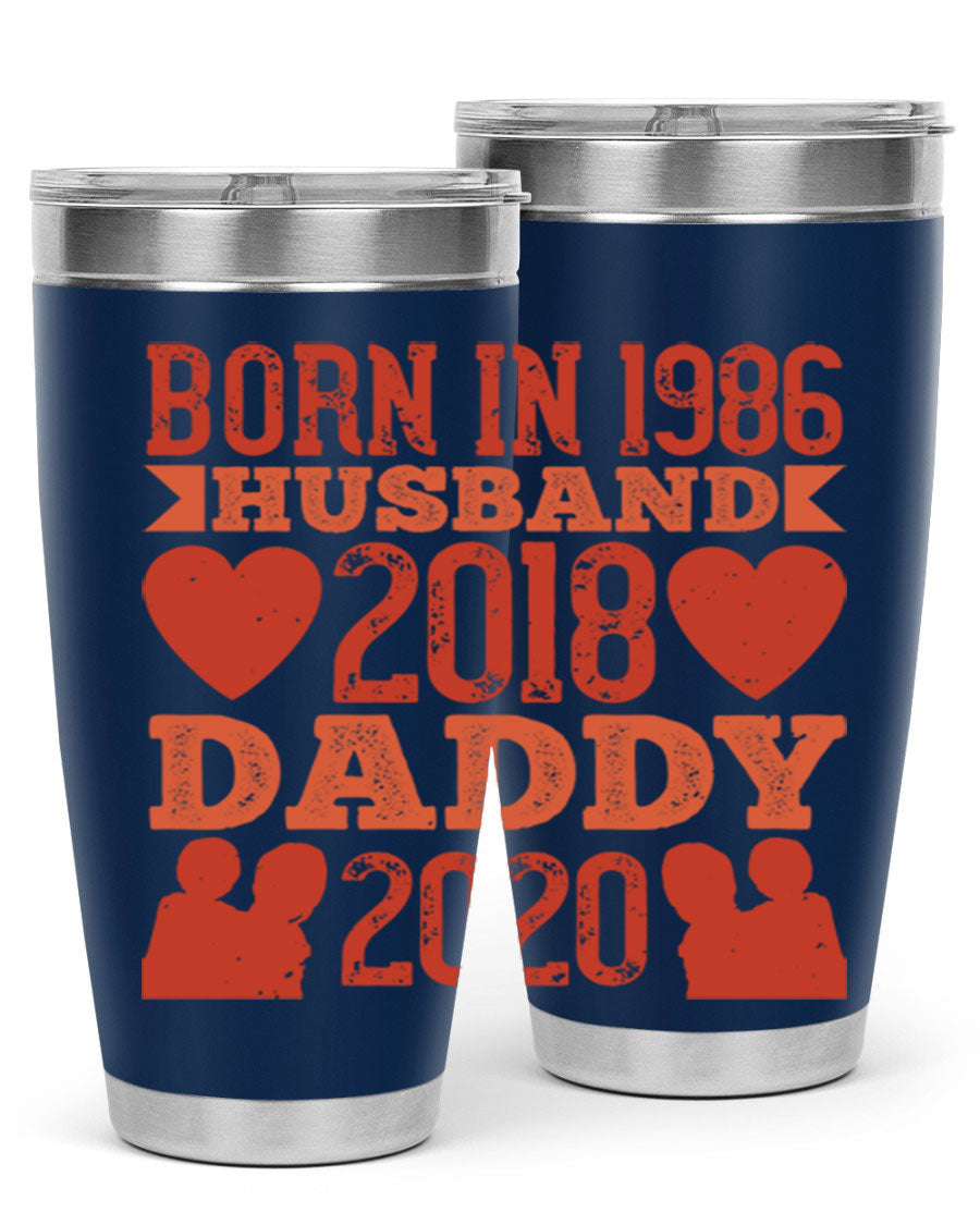 A stylish 'Born in Husband Daddy' tumbler in stainless steel, showcasing its double wall vacuum design and drink-thru lid.