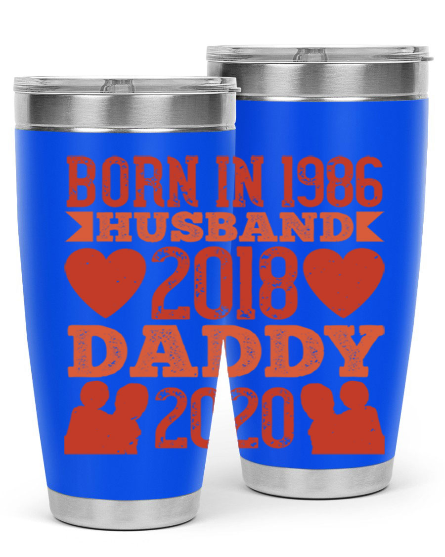 A stylish 'Born in Husband Daddy' tumbler in stainless steel, showcasing its double wall vacuum design and drink-thru lid.