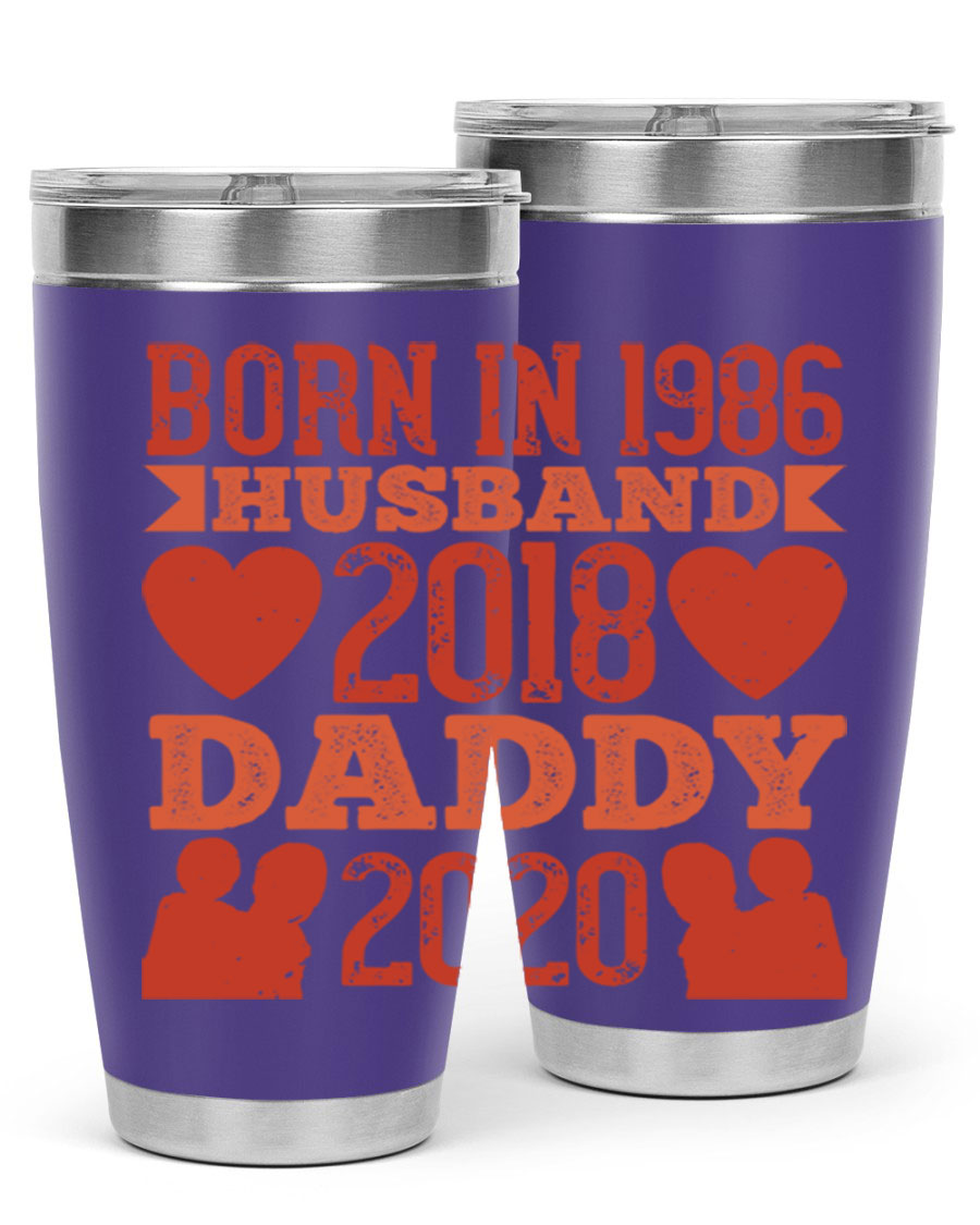 A stylish 'Born in Husband Daddy' tumbler in stainless steel, showcasing its double wall vacuum design and drink-thru lid.