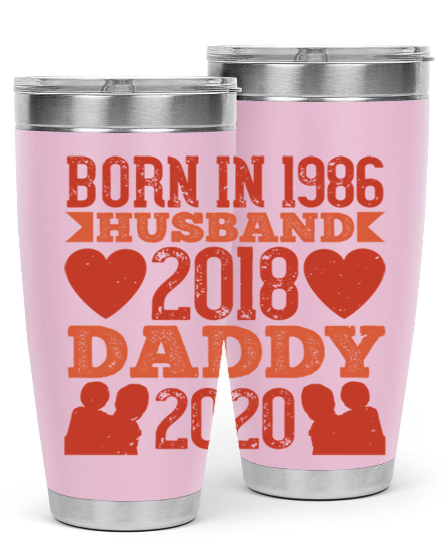 A stylish 'Born in Husband Daddy' tumbler in stainless steel, showcasing its double wall vacuum design and drink-thru lid.