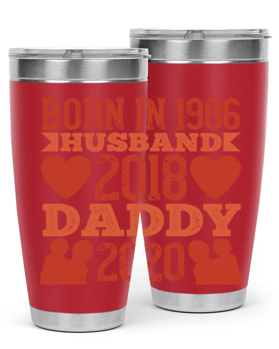 A stylish 'Born in Husband Daddy' tumbler in stainless steel, showcasing its double wall vacuum design and drink-thru lid.