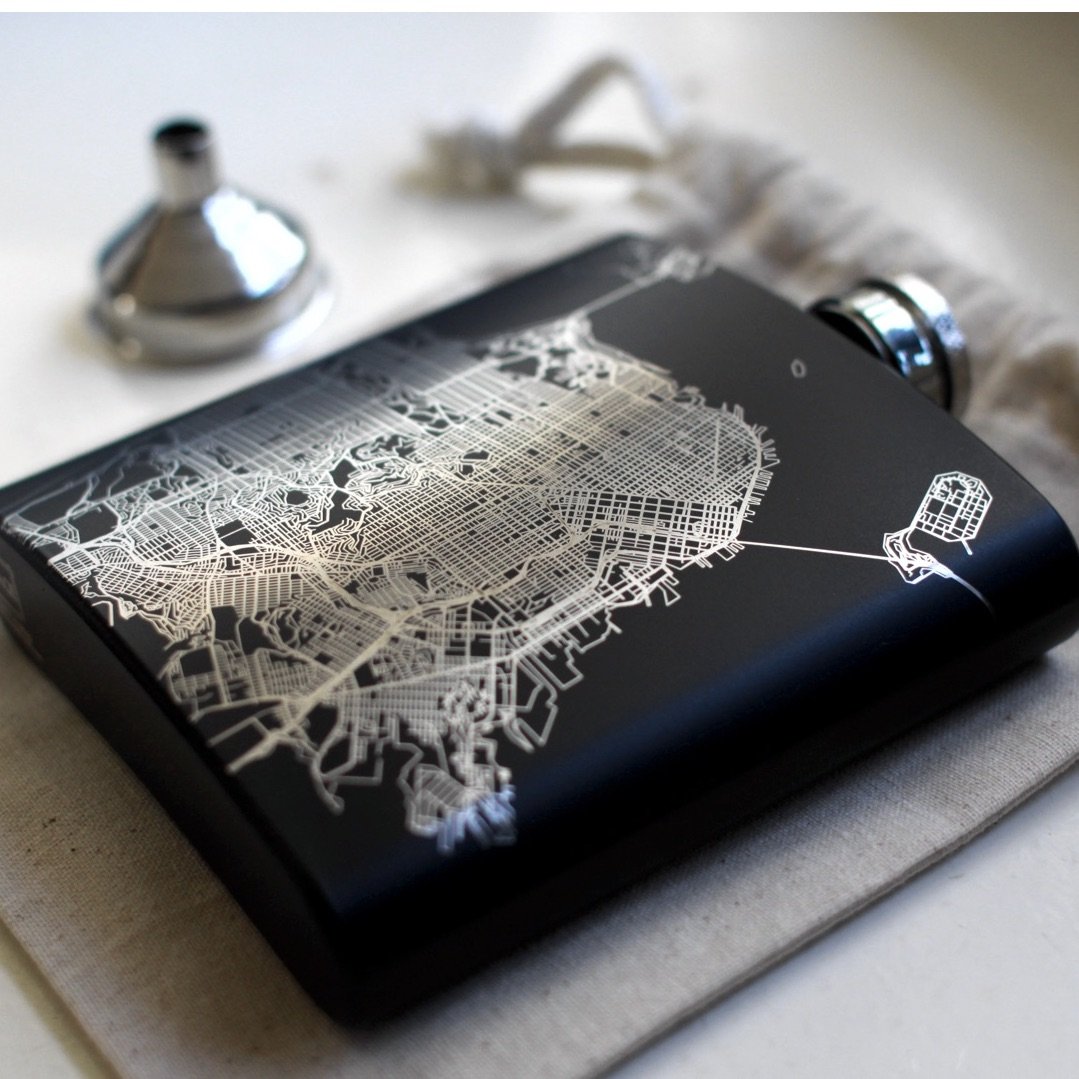 Custom engraved matte black hip flask featuring a detailed map of Boston, Massachusetts with coordinates.