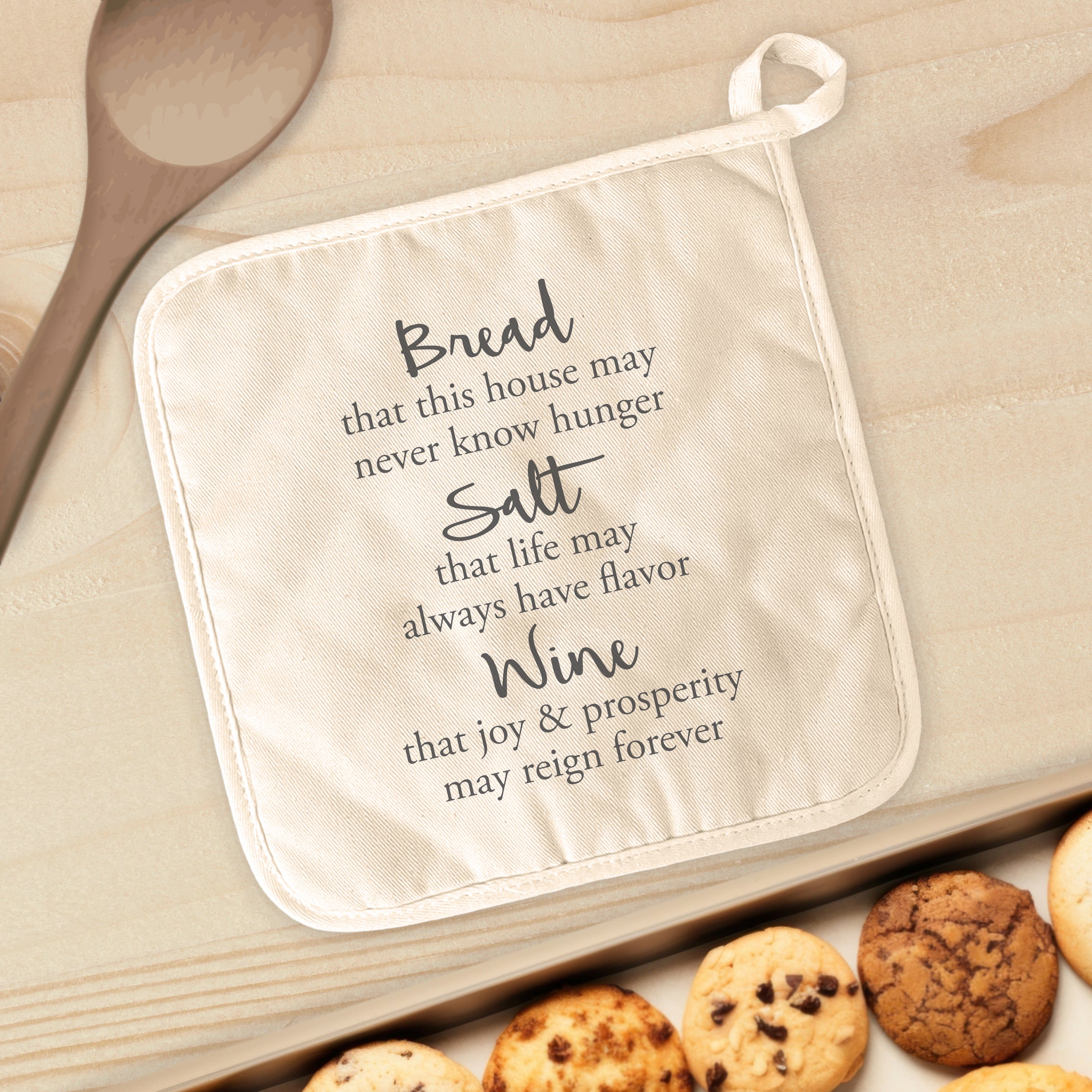 Bread, Salt, Wine cotton pot holder featuring vibrant designs and a convenient hanging loop, perfect for protecting surfaces from hot cookware.