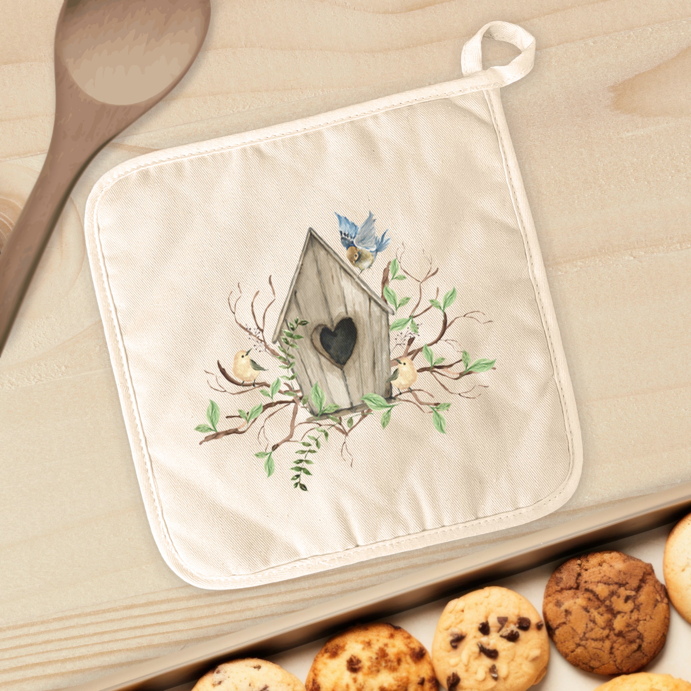 Budding Birdhouse Cotton Pot Holder featuring vibrant designs and a convenient hanging loop, perfect for kitchen use.