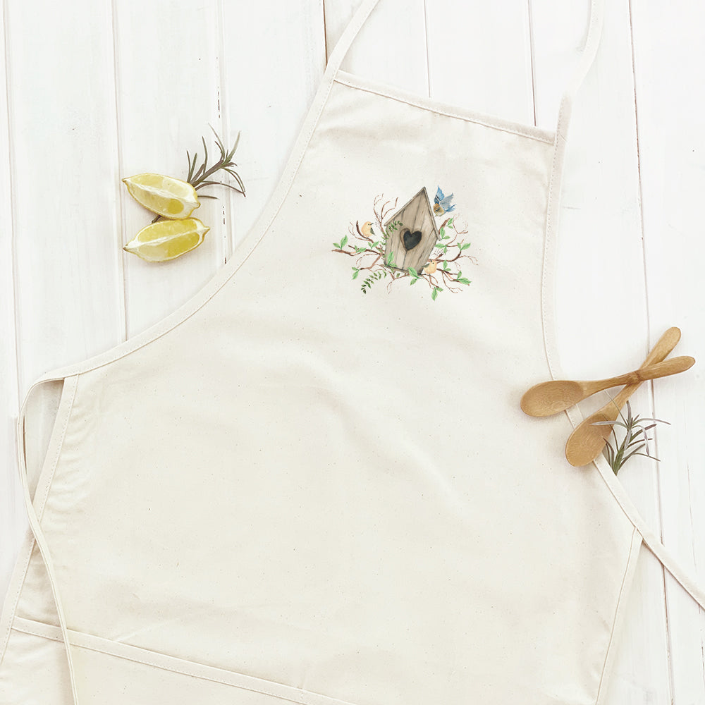 Budding Birdhouse Women's Apron featuring elegant design, cotton canvas fabric, and divided front pocket.