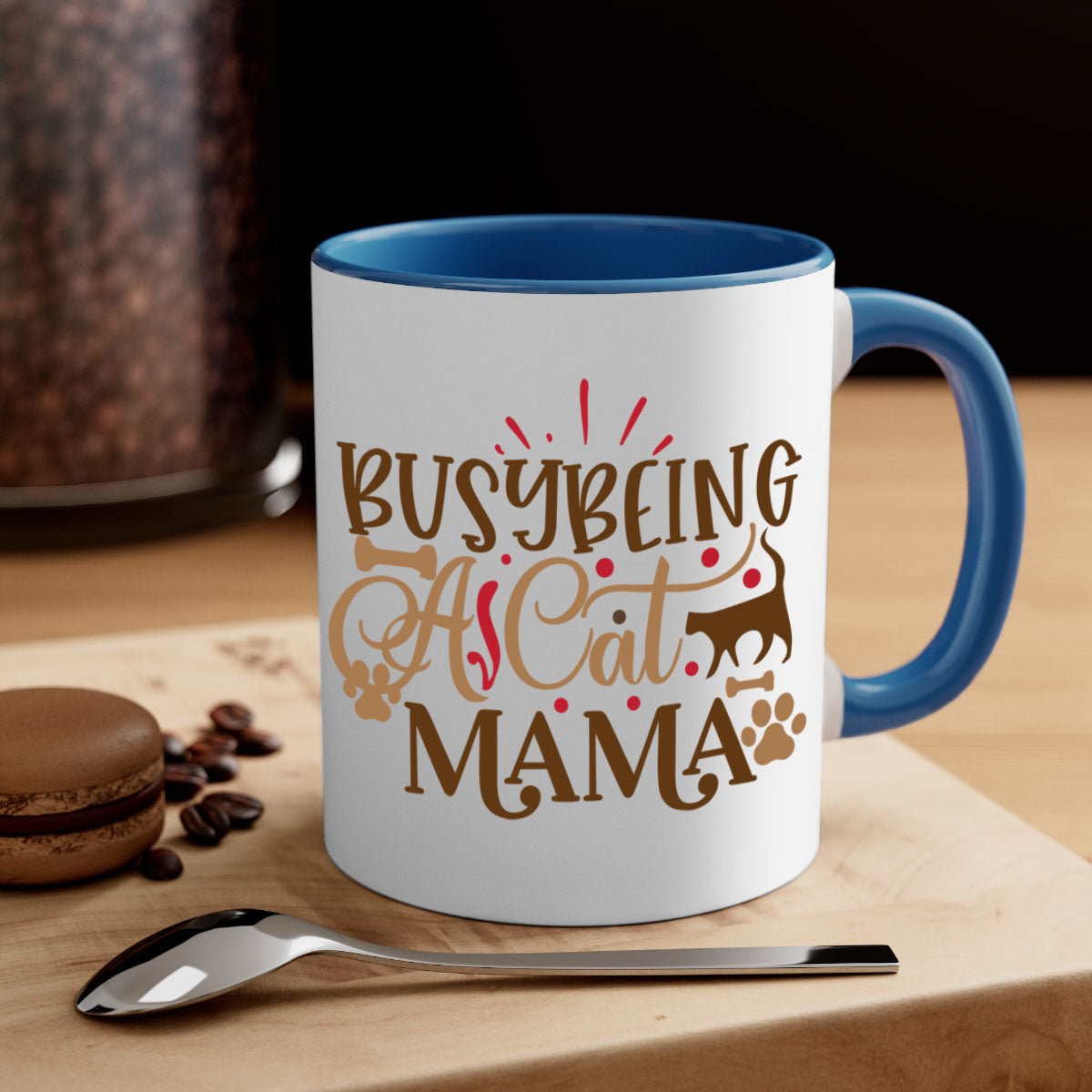 A stylish two-tone ceramic mug with a colored handle and interior, featuring the phrase 'Busy Being A Cat Mama' in a glossy finish.