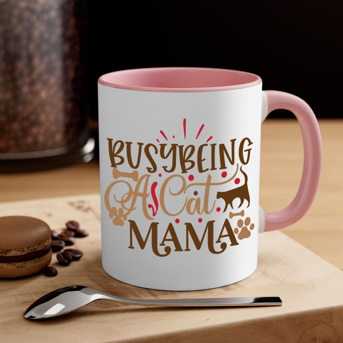 A stylish two-tone ceramic mug with a colored handle and interior, featuring the phrase 'Busy Being A Cat Mama' in a glossy finish.