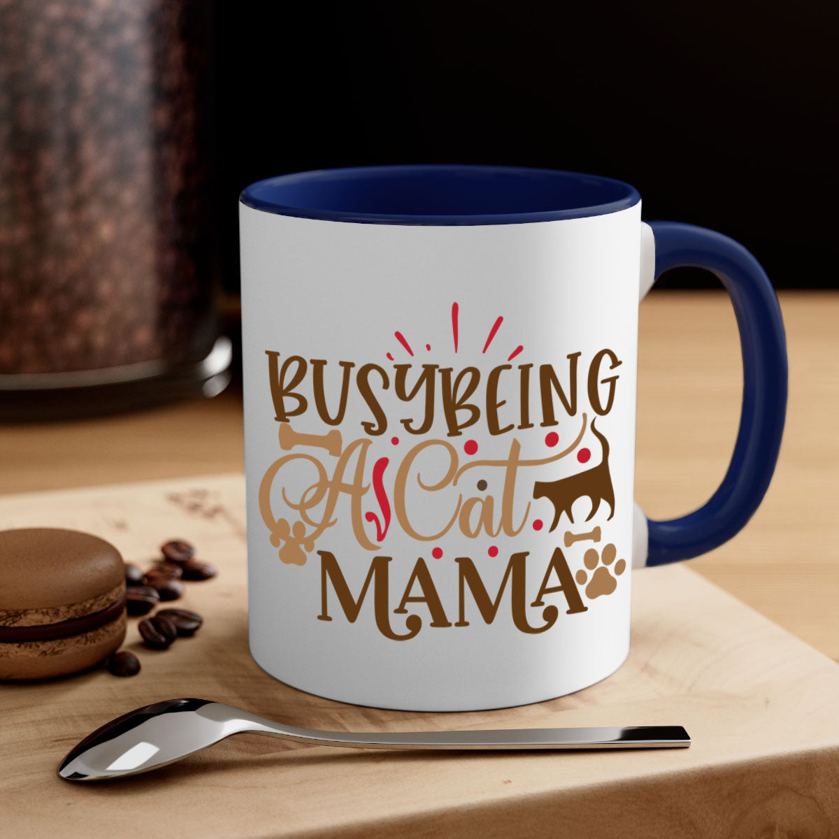 A stylish two-tone ceramic mug with a colored handle and interior, featuring the phrase 'Busy Being A Cat Mama' in a glossy finish.